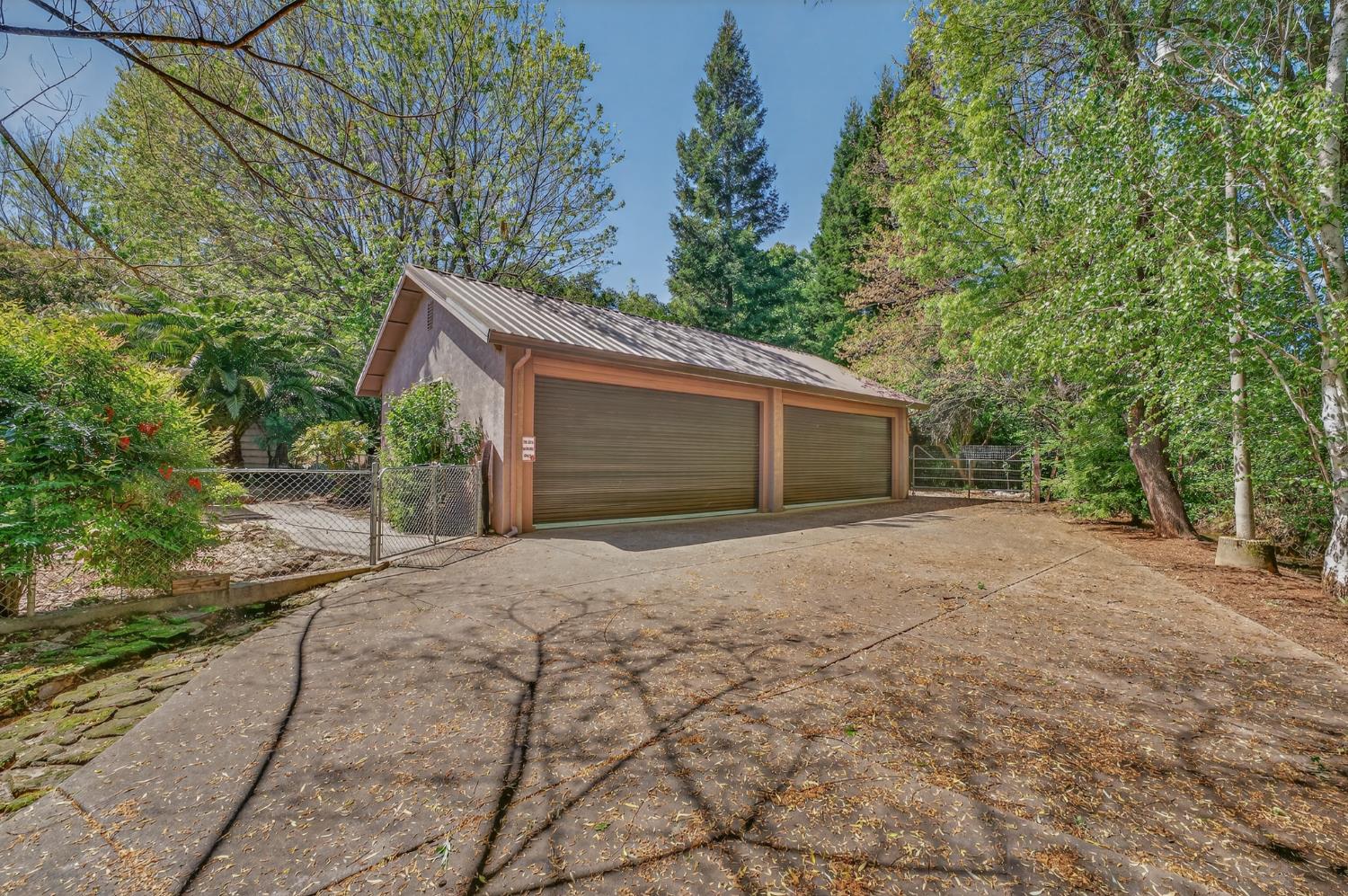 10665 Mt Vernon Road Auburn, CA 95603 - Photo 14 of 45 a front view of a house with a yard and garage