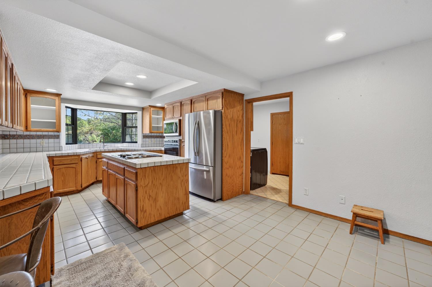 10665 Mt Vernon Road Auburn, CA 95603 - Photo 27 of 45 a kitchen with stainless steel appliances granite countertop a stove a sink and a refrigerator