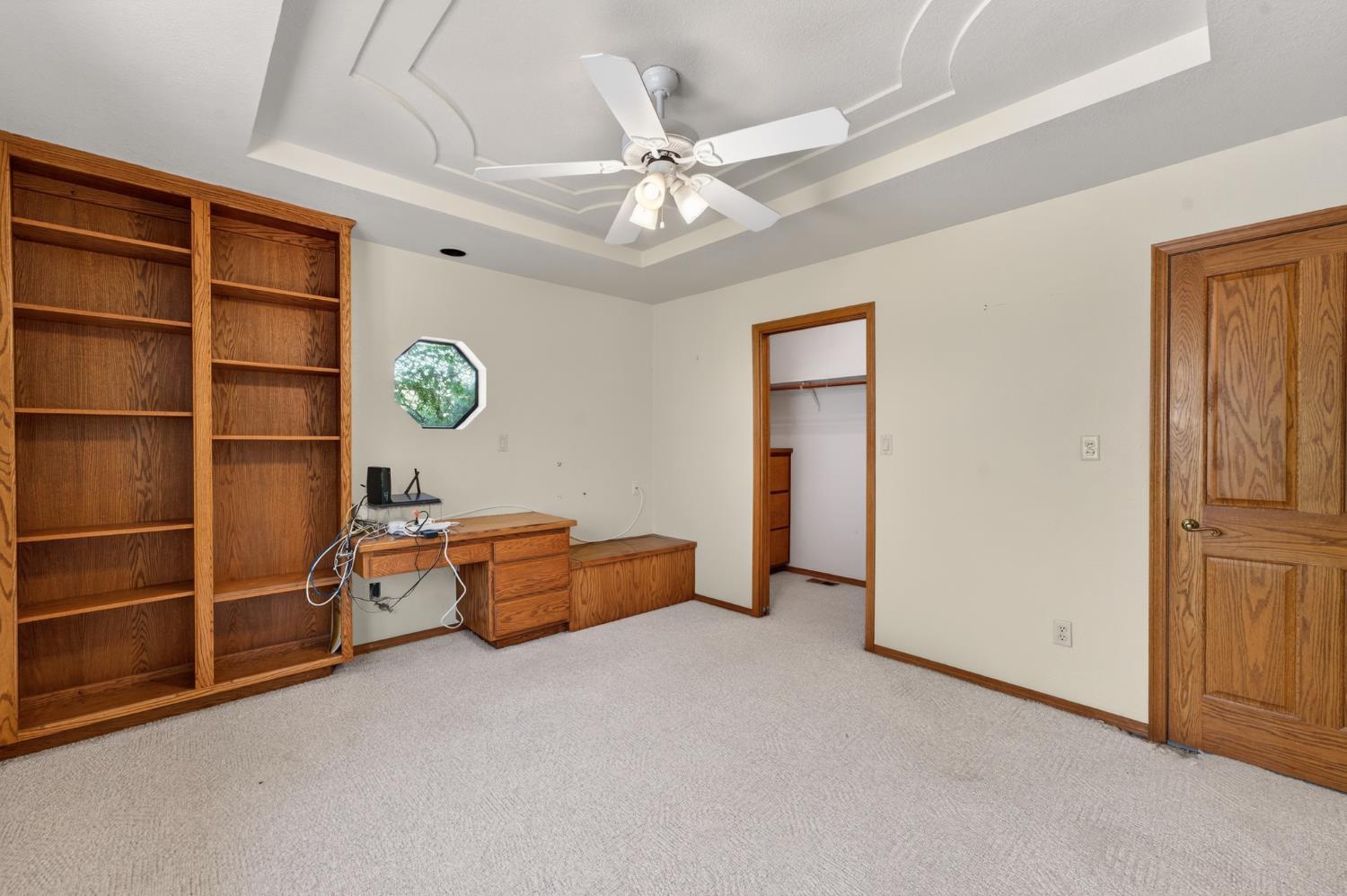 10665 Mt Vernon Road Auburn, CA 95603 - Photo 38 of 45 an empty room with windows and ceiling fan