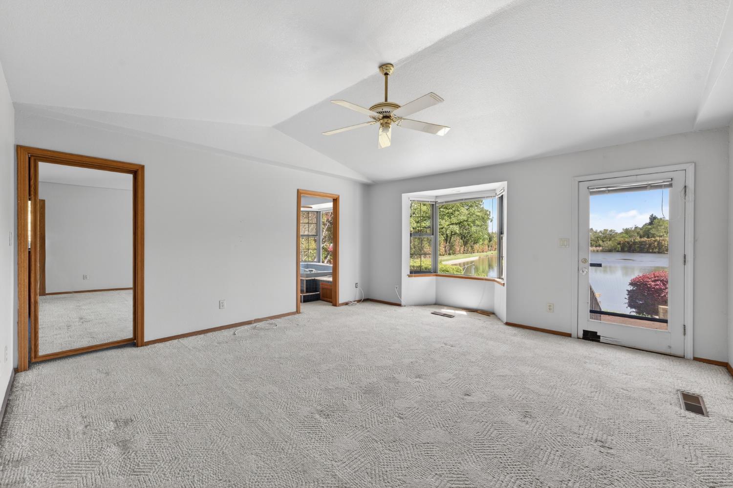 10665 Mt Vernon Road Auburn, CA 95603 - Photo 39 of 45 an empty room with windows chandelier fan and windows