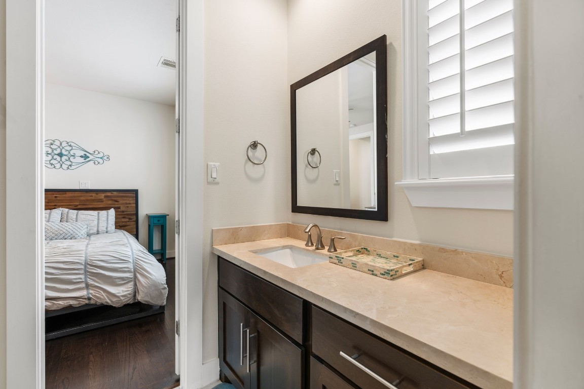 4205 Koehler Street, Unit B Houston, TX 77007 - Photo 23 of 28 a en suite bathroom with a granite countertop sink and a mirror