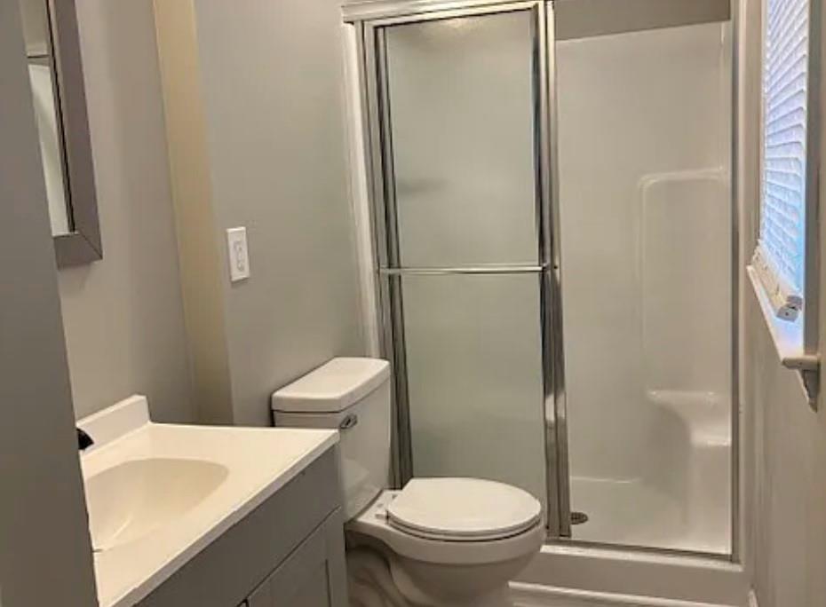 586 Ridge Avenue Mableton, GA 30126 - Photo 11 of 12 a white toilet sitting next to a bathroom sink