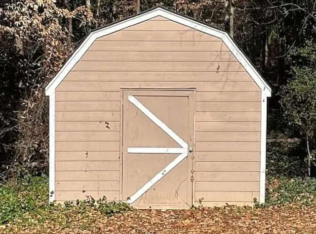 a view of wooden house with a small space