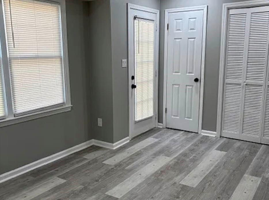 586 Ridge Avenue Mableton, GA 30126 - Photo 6 of 12 a view of an empty room with wooden floor and a window
