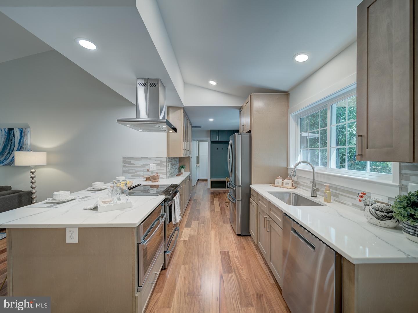 12356 Lima Lane Reston, VA 20191 - Photo 8 of 44 a kitchen with a sink stove and wooden cabinets