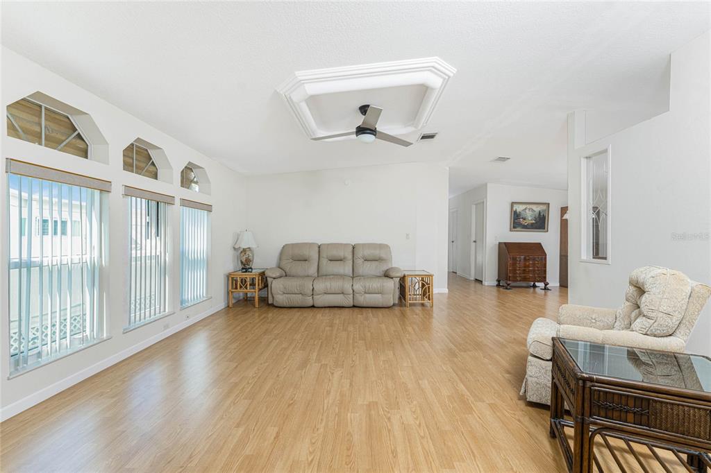 1891 Englewood Road, Unit 81 Englewood, FL 34223 - Photo 11 of 53 a living room with furniture and a fireplace