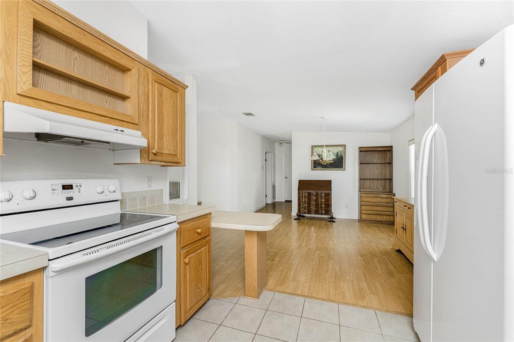 1891 Englewood Road, Unit 81 Englewood, FL 34223 - Photo 16 of 53 a kitchen with a stove and a sink
