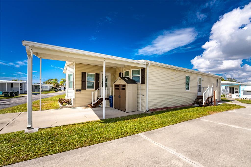 1891 Englewood Road, Unit 81 Englewood, FL 34223 - Photo 2 of 53 a view of a house with backyard and a tree