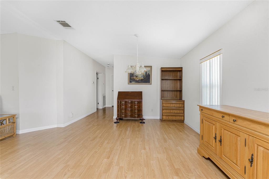1891 Englewood Road, Unit 81 Englewood, FL 34223 - Photo 21 of 53 wooden floor in an empty room with a window