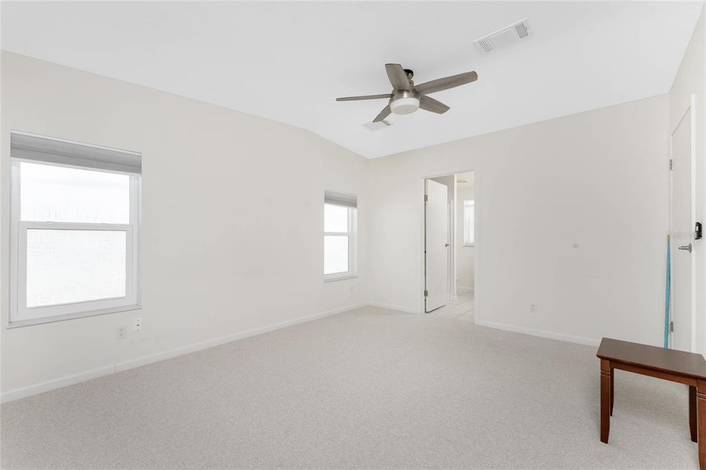1891 Englewood Road, Unit 81 Englewood, FL 34223 - Photo 25 of 53 an empty room with windows and fan