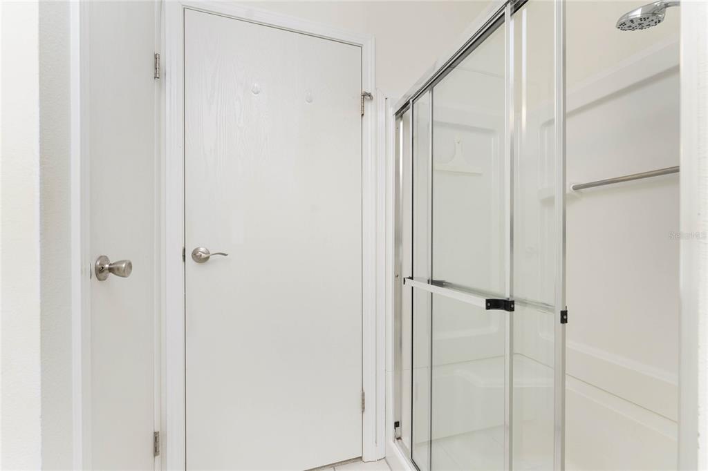 1891 Englewood Road, Unit 81 Englewood, FL 34223 - Photo 28 of 53 a bathroom with a glass shower door