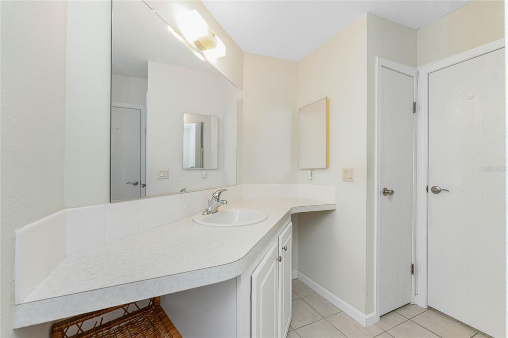 1891 Englewood Road, Unit 81 Englewood, FL 34223 - Photo 29 of 53 a bathroom with a sink and a mirror