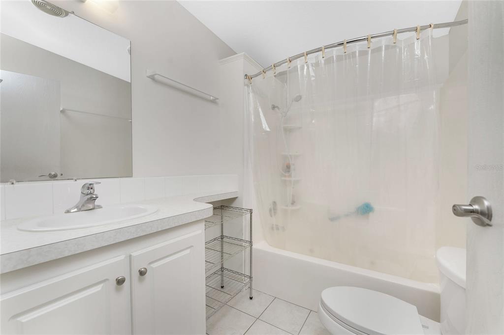 1891 Englewood Road, Unit 81 Englewood, FL 34223 - Photo 33 of 53 a bathroom with a sink toilet and shower