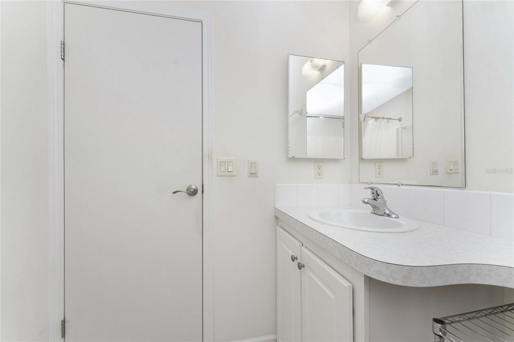 1891 Englewood Road, Unit 81 Englewood, FL 34223 - Photo 35 of 53 a bathroom with a sink and a mirror