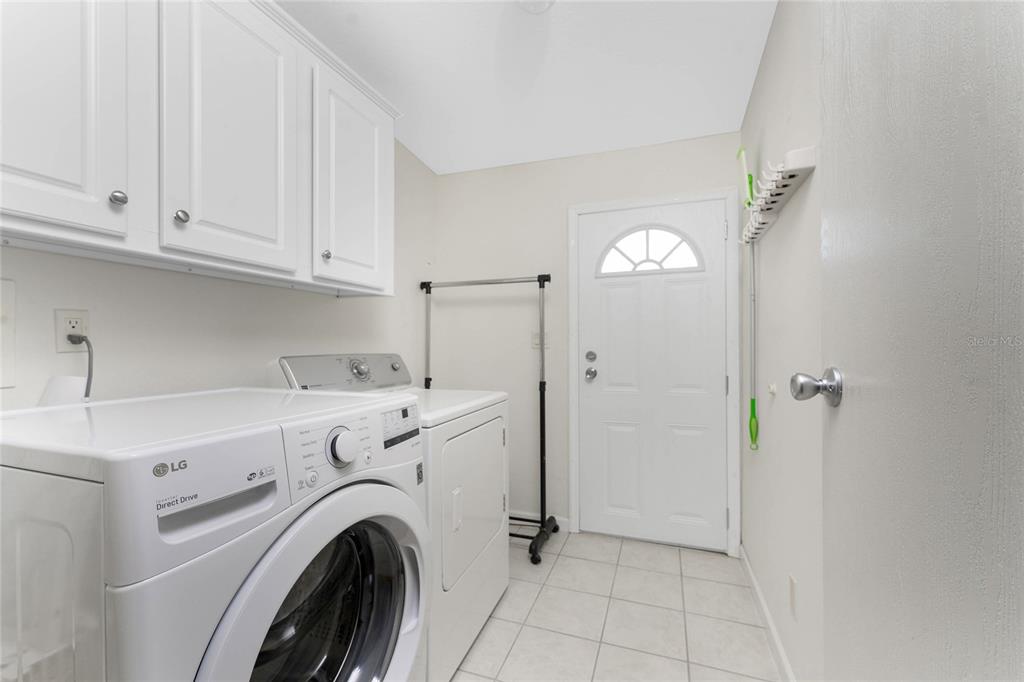 1891 Englewood Road, Unit 81 Englewood, FL 34223 - Photo 36 of 53 a view of a hallway with washer and dryer