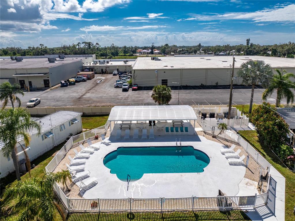 1891 Englewood Road, Unit 81 Englewood, FL 34223 - Photo 37 of 53 a view of a swimming pool and lounge chair