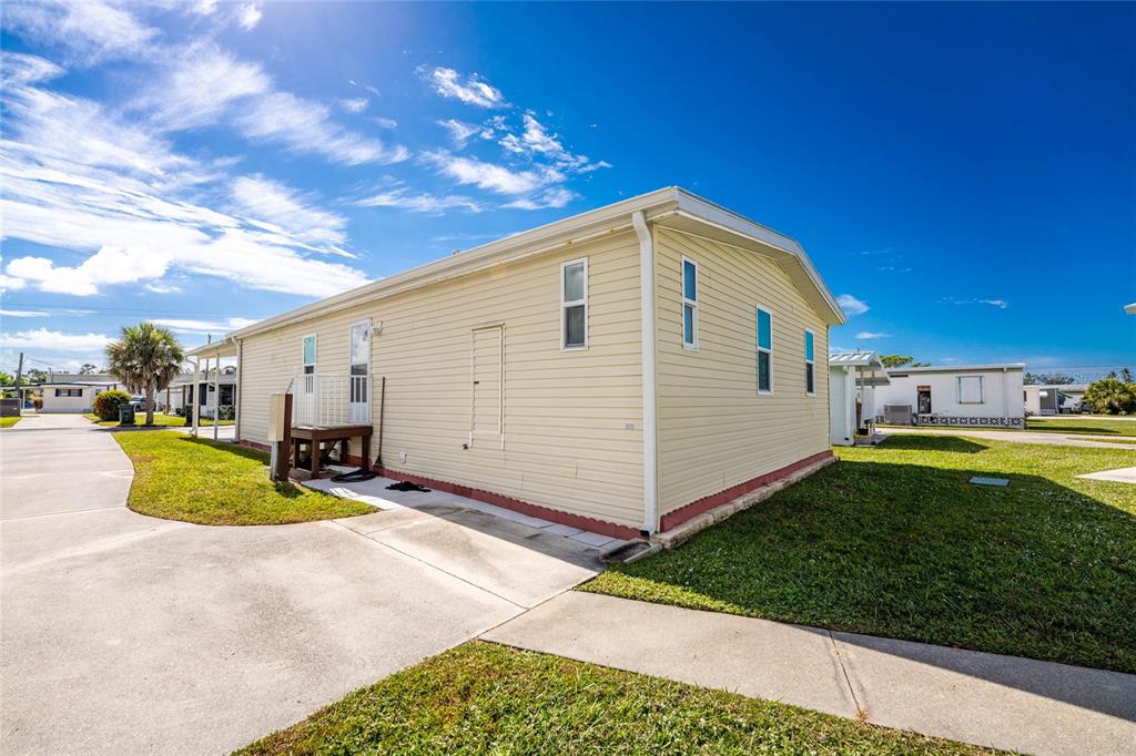 1891 Englewood Road, Unit 81 Englewood, FL 34223 - Photo 44 of 53 a view of a house with backyard and sitting area