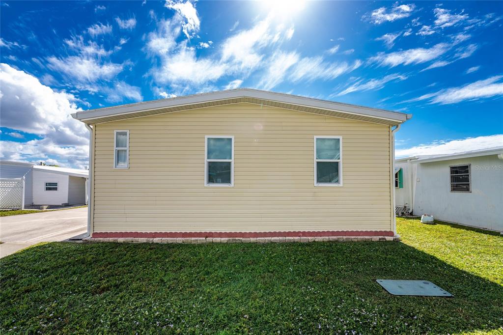 1891 Englewood Road, Unit 81 Englewood, FL 34223 - Photo 45 of 53 a view of a house with a backyard