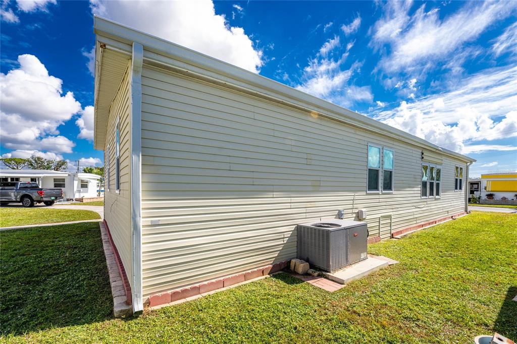 1891 Englewood Road, Unit 81 Englewood, FL 34223 - Photo 46 of 53 a view of a house with backyard and sitting area