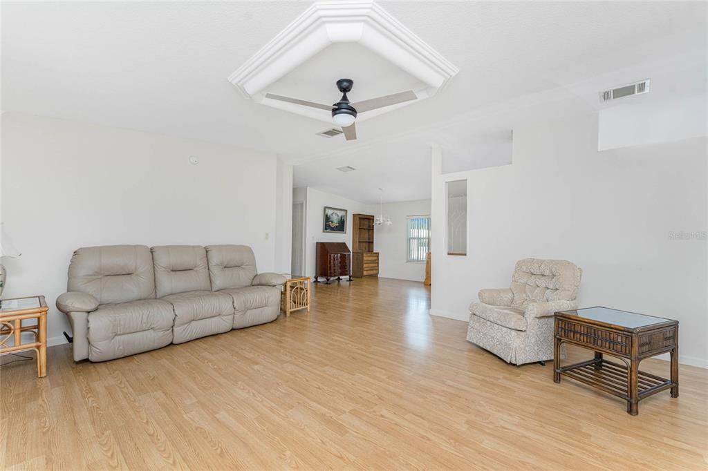 1891 Englewood Road, Unit 81 Englewood, FL 34223 - Photo 10 of 53 a living room with furniture and a wooden floor