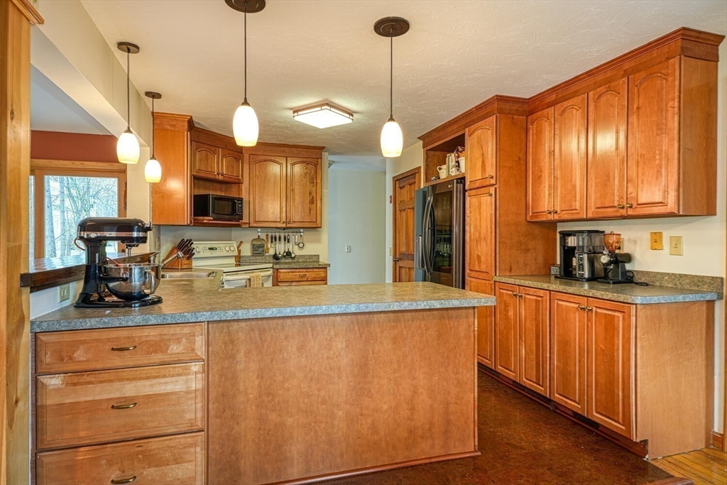60 Coal Kiln Road Princeton, MA 01541 - Photo 4 of 31 a kitchen with stainless steel appliances granite countertop a sink a stove and a wooden floors