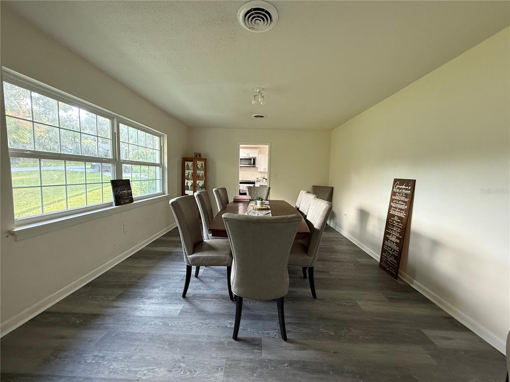 1021 Southwest 26th Street Ocala, FL 34471 - Photo 6 of 10 a view of a dining room with furniture window and wooden floor