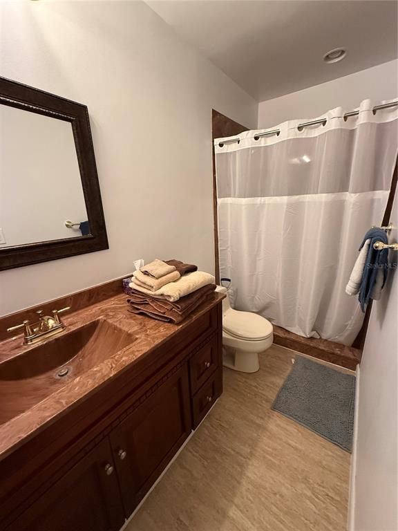 1021 Southwest 26th Street Ocala, FL 34471 - Photo 10 of 10 a bathroom with a granite countertop sink toilet and shower