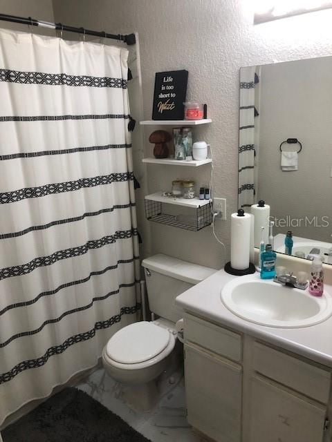 1025 South Hiawassee Road, Unit 2226 Orlando, FL 32835 - Photo 5 of 7 a bathroom with a sink toilet and shower