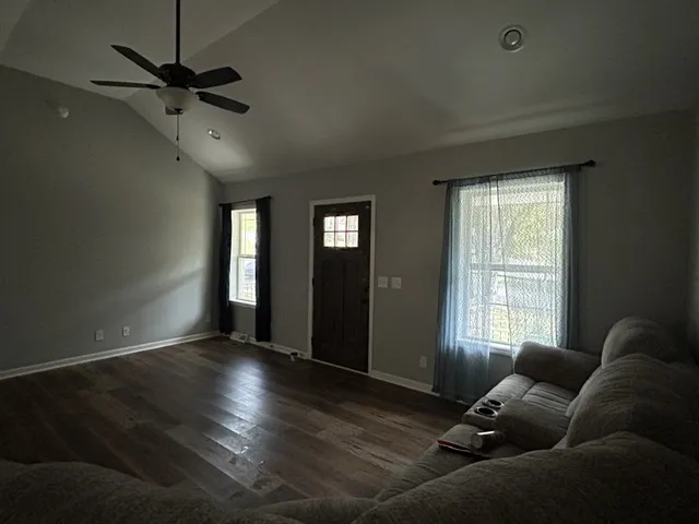 a living room with couches and a window