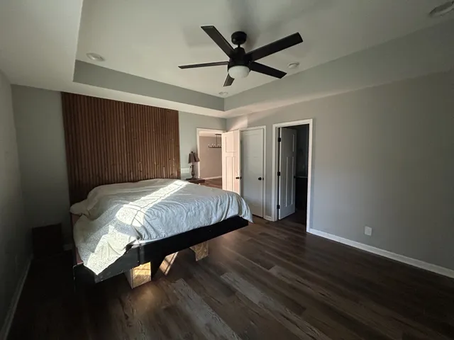 a bed room with a bed and a ceiling fan