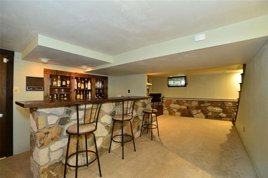 12780 Ridge Road North Huntingdon, PA 15642 - Photo 12 of 21 The huge bar area is perfect for social gatherings and complements the unique details of this home. The stone adds so much interest and functionality to the bar.