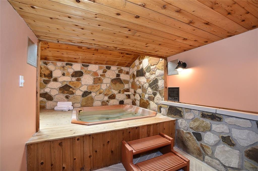 12780 Ridge Road North Huntingdon, PA 15642 - Photo 13 of 21 The hot tub and lounging area of this home are something to be seen! Relax and unwind in your very own hot tub on a daily basis. The stunning wood and stone add even more to the relaxing atmosphere!