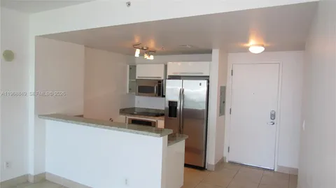 a kitchen with cabinets and stainless steel appliances