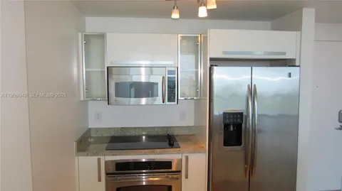 a kitchen with a refrigerator and a stove