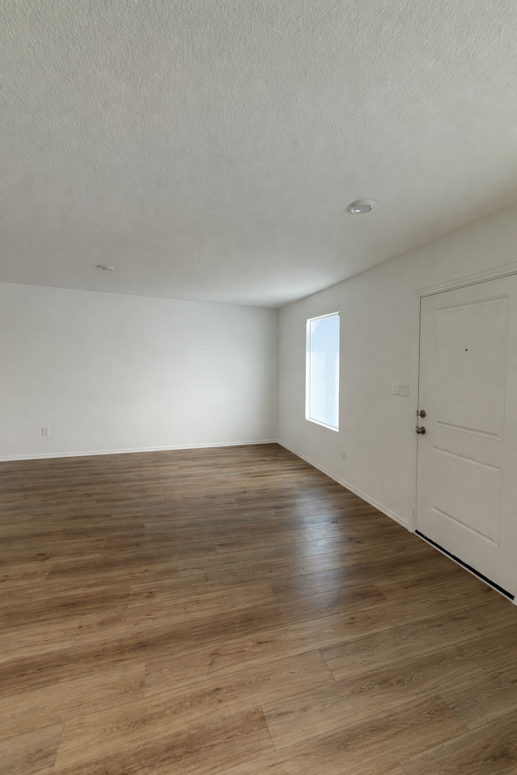 23408 Tiny Moons Way Elgin, TX 78621 - Photo 2 of 11 a view of an empty room with wooden floor and a window