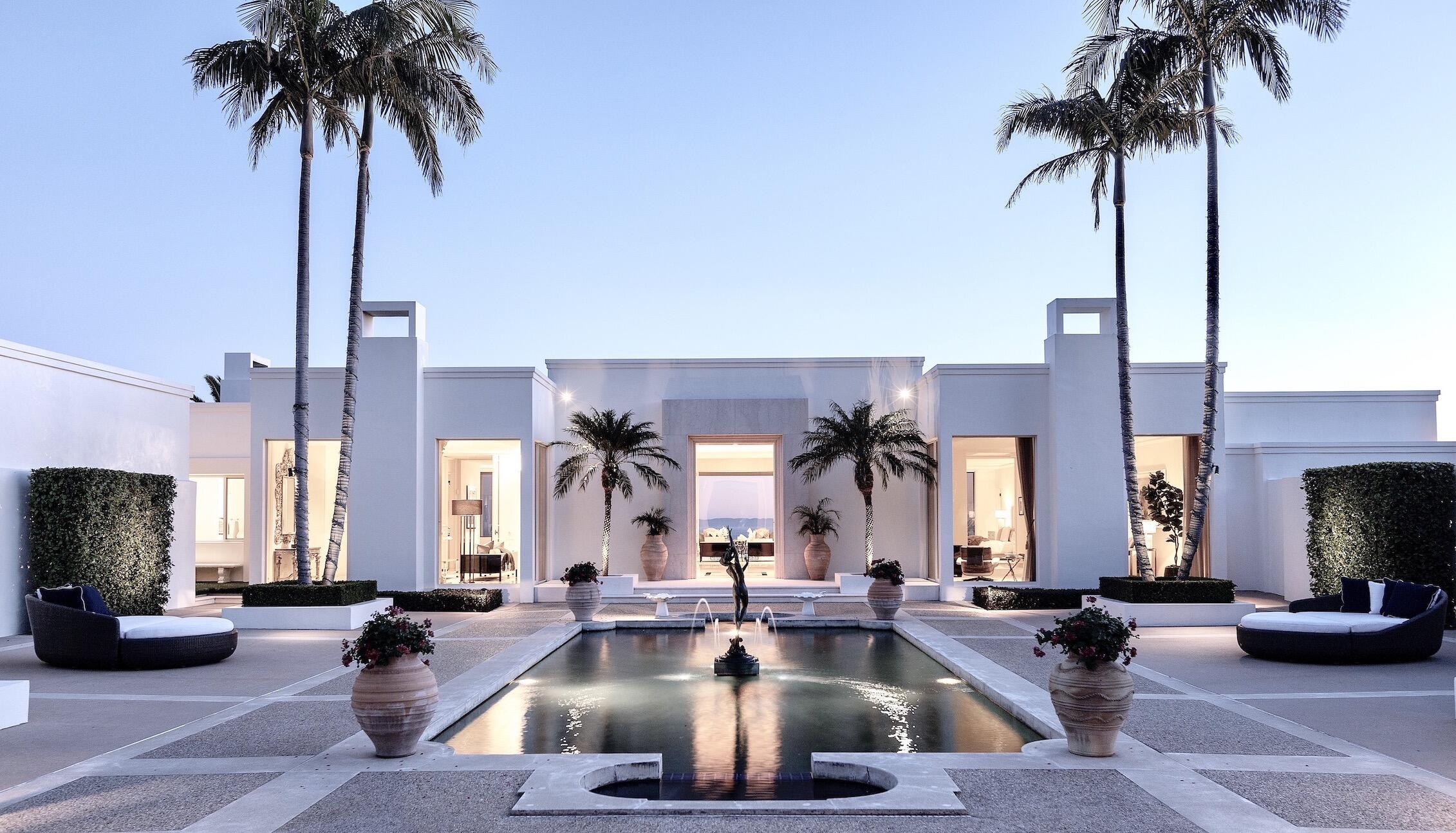 an outdoor living space with furniture and a fireplace