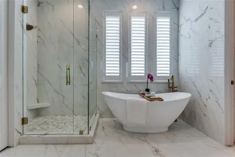 a bath tub sitting in a bathroom next to a window