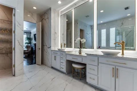 a spacious bathroom with a double vanity sink a mirror and a shower