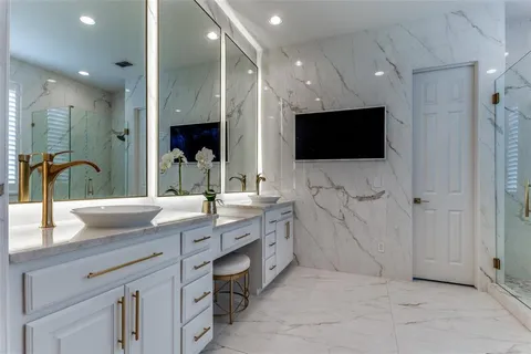 a bathroom with a double vanity sink and a mirror