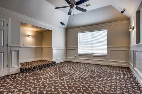 a living room with a black white checkered floor with a large window and wooden floor