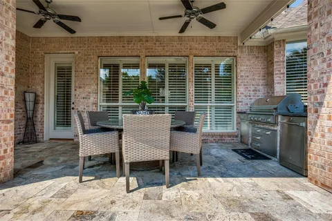 a view of a porch with a table and chairs