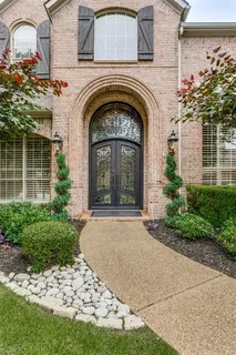 a front view of a house with plants