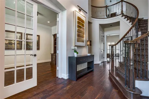 a view of front door and porch with wooden floor