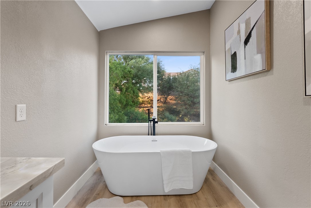 1662 Ravanusa Drive Henderson, NV 89052 - Photo 44 of 74 Indulge in relaxation with this elegant freestanding tub and scenic outdoor views.
