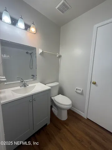 a view of bathroom with a sink toilet and a mirror