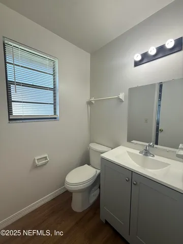 a bathroom with a sink a toilet and mirror