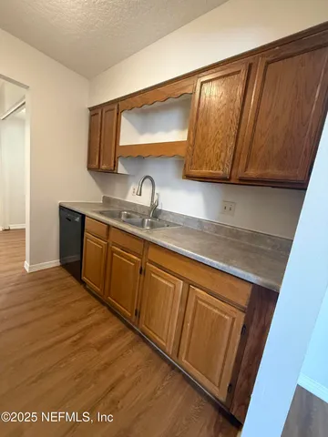 a kitchen with a sink a cabinets and window