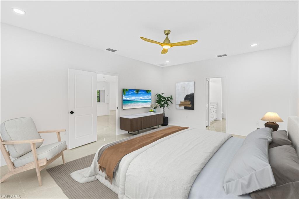 343 Pullman Street Lehigh Acres, FL 33974 - Photo 17 of 43 a bedroom with a bed a chandelier and a painting on the wall