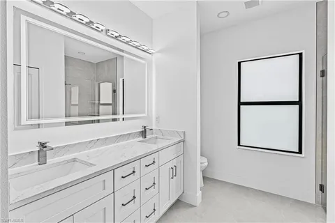a bathroom with a double vanity sink and a mirror