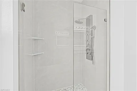 a bathroom with a glass shower door